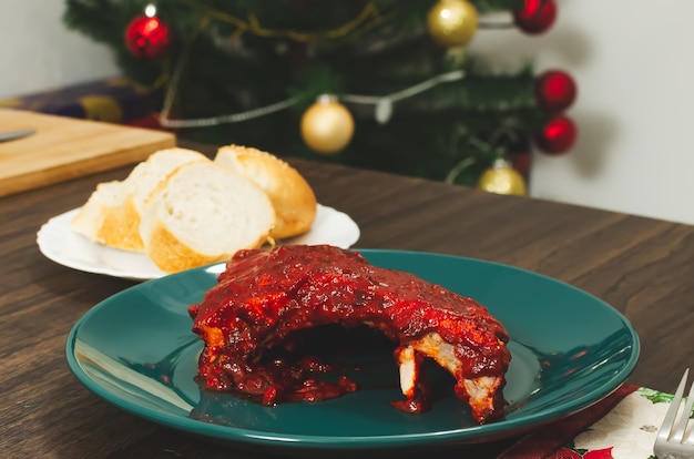 Roasted ribs marinated with barbecue sauce on wooden table