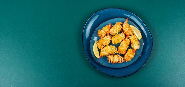 Roasted rolled potato shrimps prawns and potato rolls Copy space Asian food