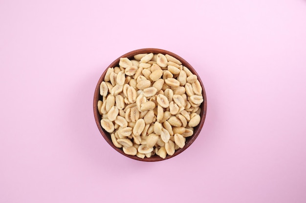 Roasted salted delicious peanuts on a bright light background