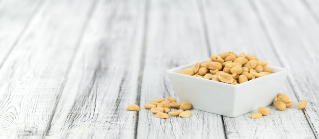 Roasted and salted Peanuts on vintage background