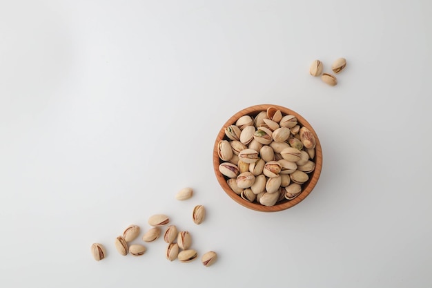 Roasted and salted pistachios in shell on white background