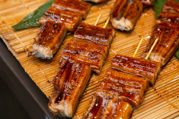 Roasted skewered eel at a food market in the city of Osaka in Japan