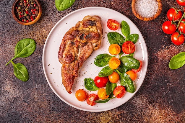 Roasted turkey steak with salad.