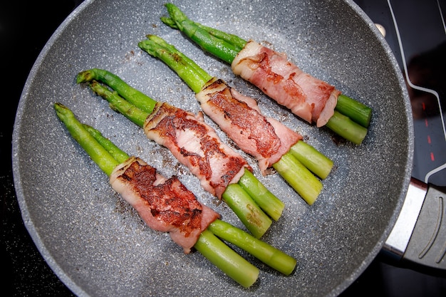 Roasted vegetable and bacon on a pan.