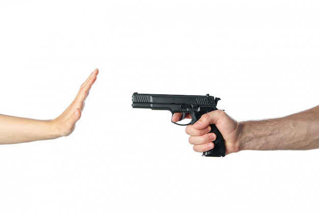 The robber pointed a hand with a gun at a woman, isolated on white