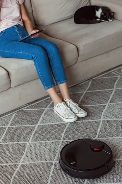 Photo robot vacuum cleaner cleaning carpet