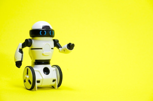 Robot on a yellow background with a place for text