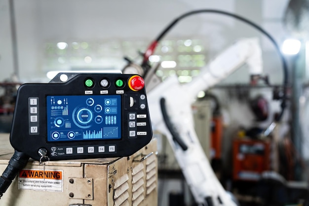 Robotic arm and its controller adept panel in a factory workshop