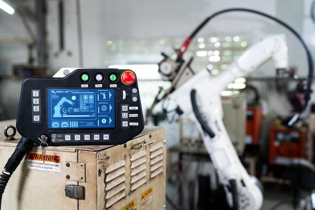 Robotic arm and its controller adept panel in a factory workshop