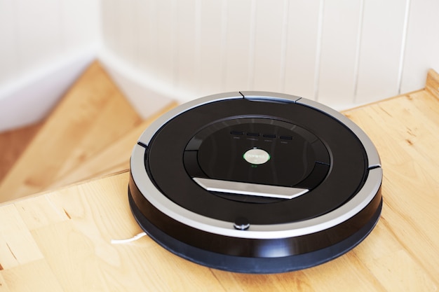 Robotic vacuum cleaner on laminate wood floor smart cleaning technology stairs