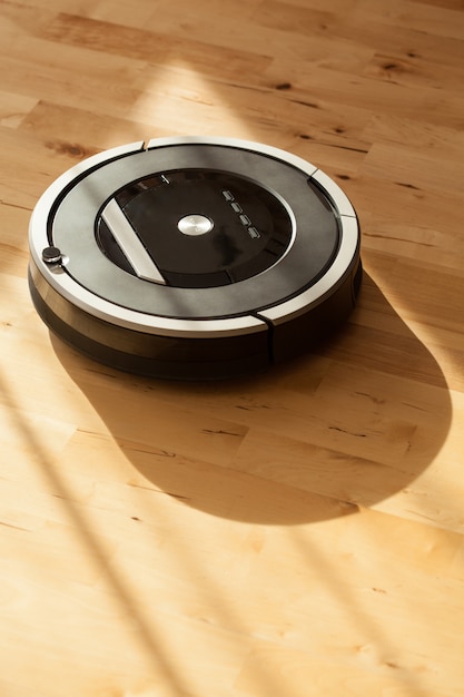 Robotic vacuum cleaner on laminate wood floor smart cleaning technology