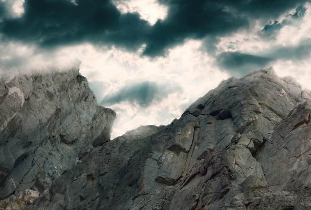 Rock against a dark dramatic sky with clouds