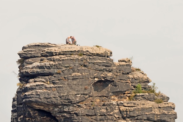 The rock against the sky with the climbers on the surface