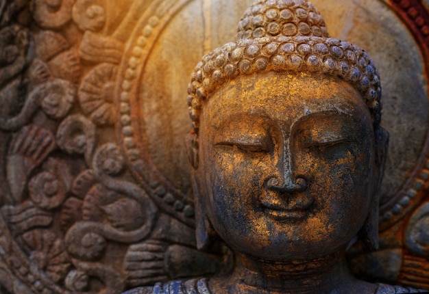 Rock Buddha statue with sunlight used for amulets of Buddhism religion. 