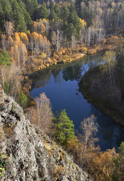 the rock st johns wort spurs of the salair ridge the banks of the river with autumn forest