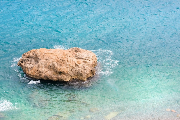 Rock stone in the blue sea