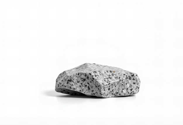 Photo a rock with a gray background and a black speckled rock on the left