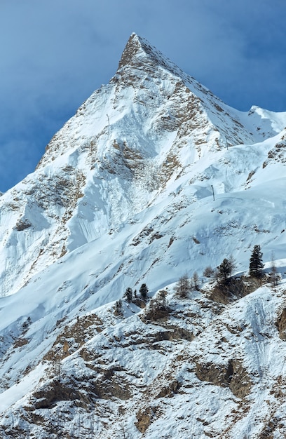 Rock with a pointed top. Winter snowy peaceful Samnaun Alps landscape (Swiss).