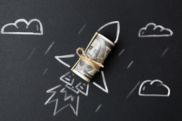 Photo rocket with a roll of dollars the concept of financial success and wealth growth in business