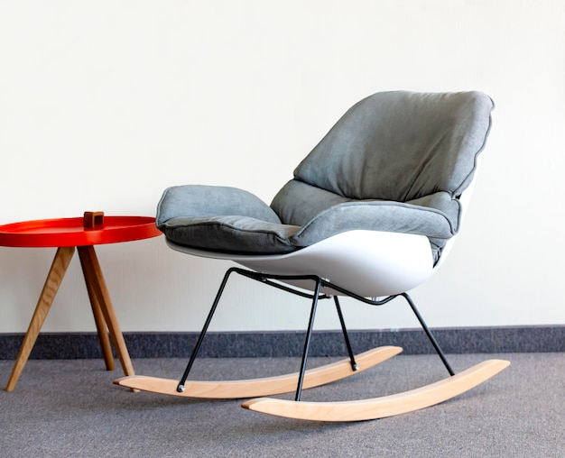 Rocking chair and table against the wall interior inside