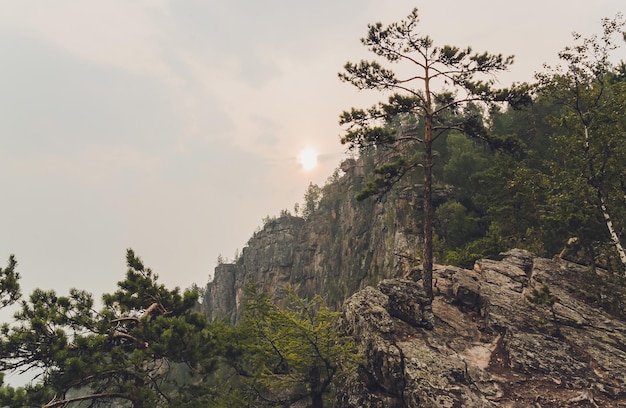 Rocks of Aigir in the smoke of a forest fire Bashkortostan