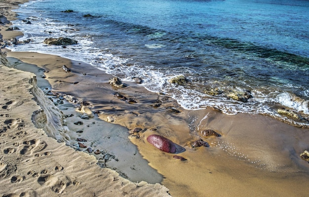 Rocks on Castelsardo golden shore Italy