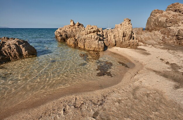 Rocks, crystal clear sea water and sun the perfect symbol of a summer holiday in a true paradise
