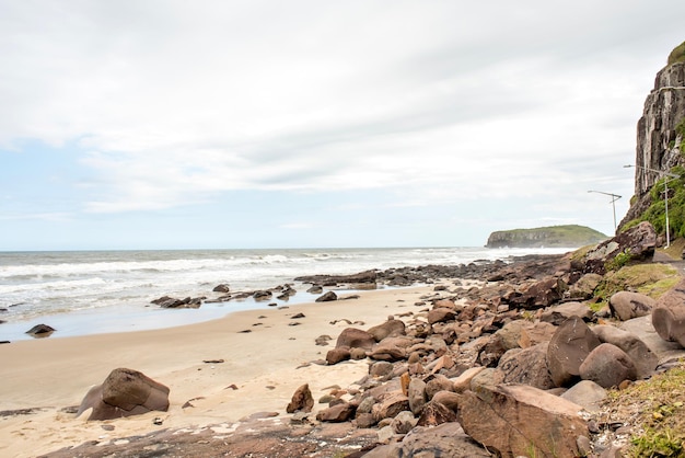 Rocks in the sand on South American sea Torres beach Rio Grande do Sul Brazil