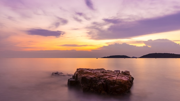 Rocks at topical beach at beautiful sunset. Nature sea background.