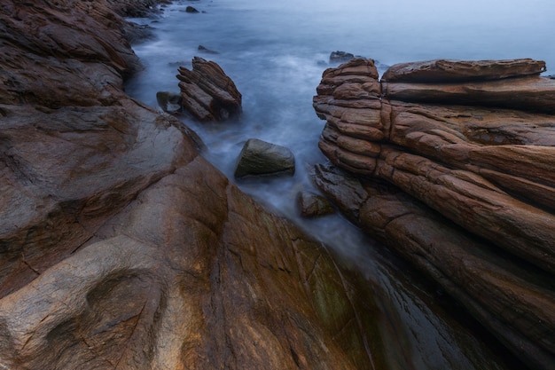 Rocky beach with the water hitting before the rain