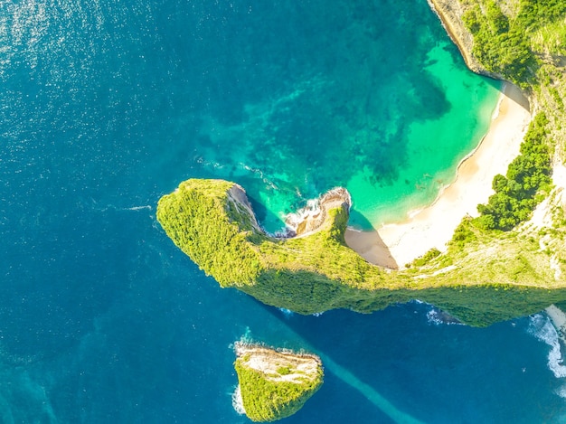 Rocky coast of a tropical island. Empty beach and small island. Sunny weather. Aerial view