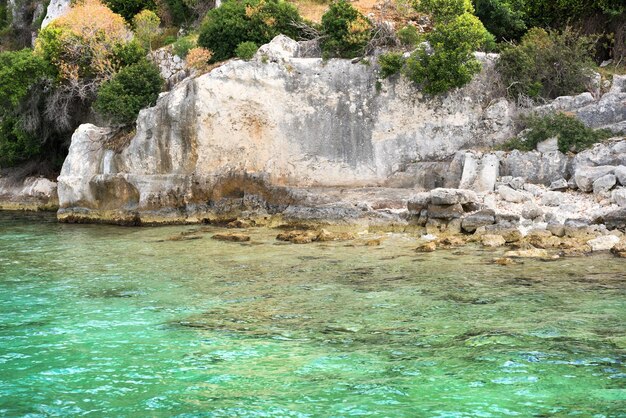 Rocky coast with green trees Aquamarine sea Beautiful view