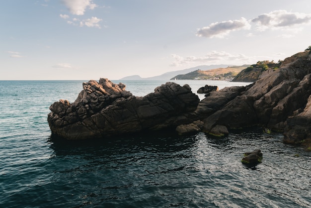 Rocky ledge crashes into the sea