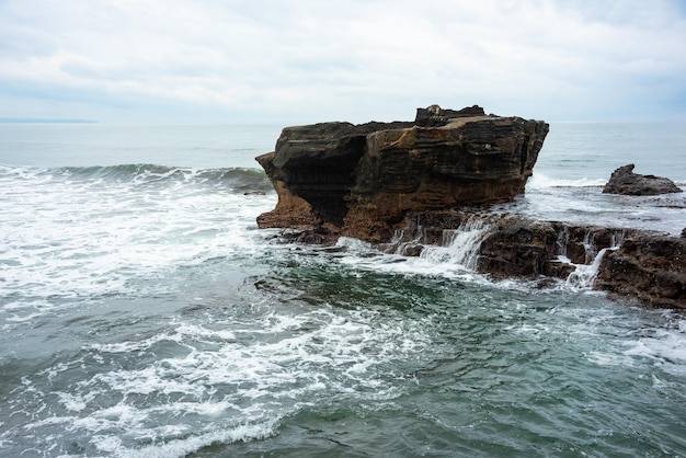 Rocky sea coast hit by waves on Bali island