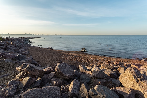 Rocky seashore under the morning sunlight in Saint Petersburg, Russia.