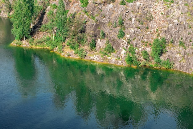 The rocky shore at the azure reservoir. The beauty of the wild. A place untouched by man.