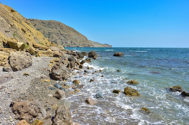 Rocky shore of Black Sea landscape with rocks on seashore rocks sticking out of sea