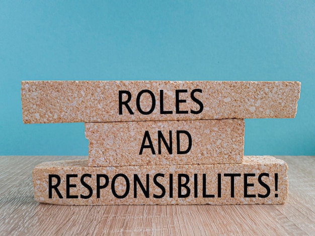 Photo roles and responsibilities symbol concept words roles and responsibilities on brick blocks