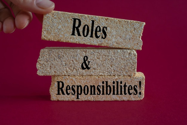 Photo roles and responsibilities symbol concept words roles and responsibilities on brick blocks