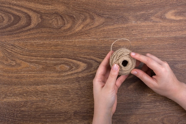 Roll of brown linen string on brown background