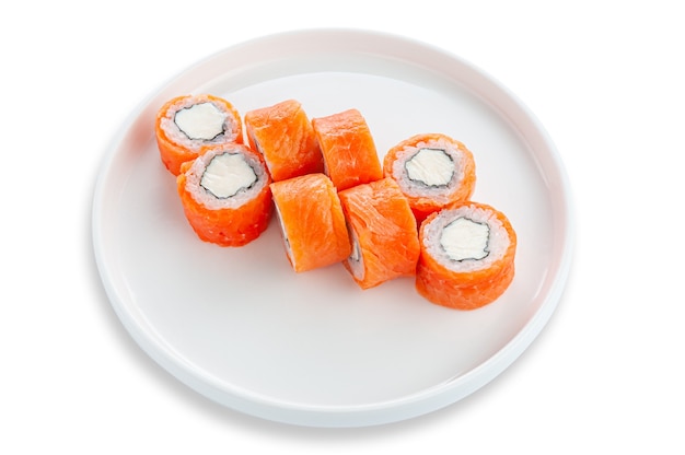 Roll Philadelphia with salmon and cream cheese. On a white ceramic plate. White background. Isolated.