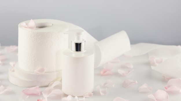 Roll of toilet paper with cosmetic dispenser bottle