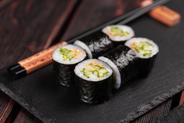 Roll with fish sushi with chopsticks asian food concept