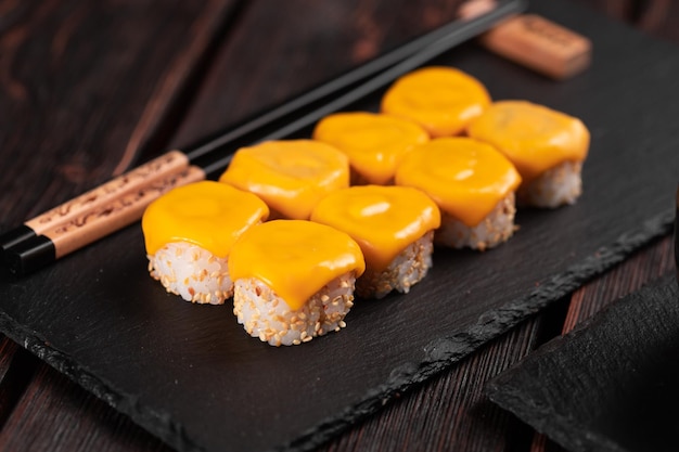 Roll with fish sushi with chopsticks asian food concept