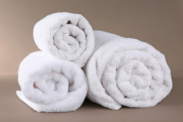 Rolled terry towels on color background