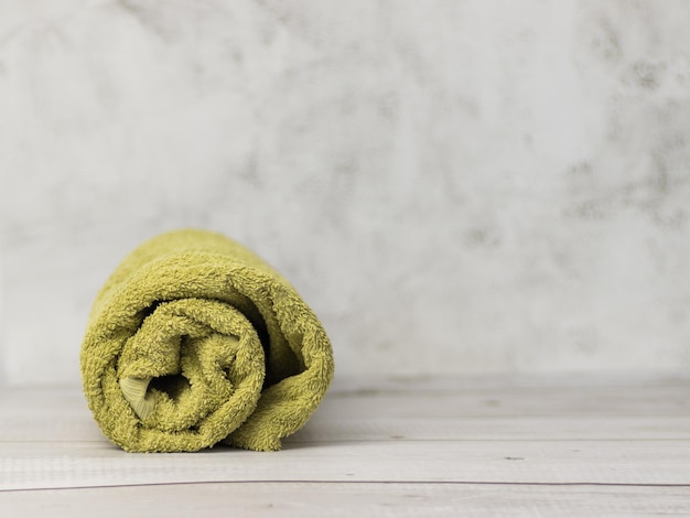 Photo rolled towels on wooden table in bathroom green