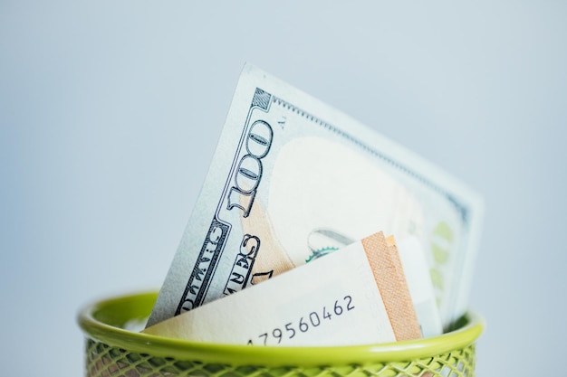 Rolled up banknotes of money American dollars in a metal cup