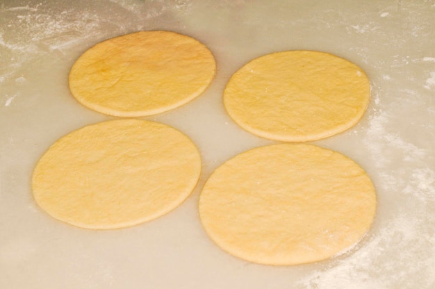 Rolling out the dough to make dumplings