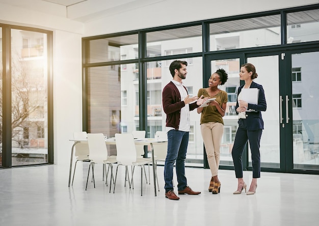 Rolling out a quick update to the team Shot of a group of colleagues having a meeting in a modern office