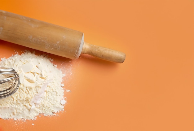 A rolling pin with flour on it and a rolling pin on the side.